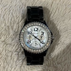 Black watch with pearl face and diamonds around